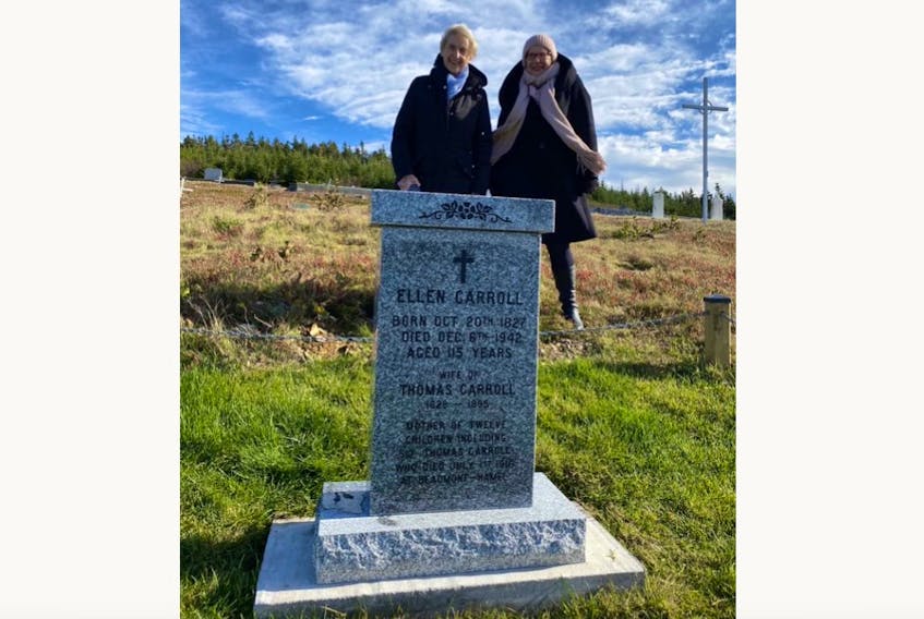 Anne Galway, great-granddaughter of Ellen Dwyer Carroll, and Beatrice Ruelokke of Nelson Monuments pose for a photo of Carroll’s new headstone at All Hallows Cemetery in North River.