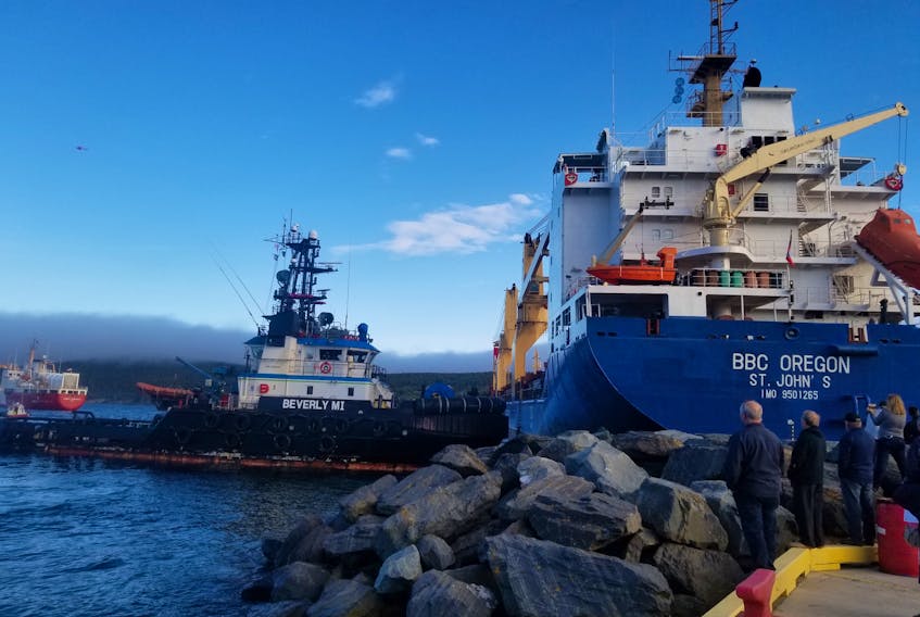 A tug pulls a ship off the rocks in Bull Arm, N.L. this past June. The tug business in Atlantic Canada is very competitive. - Coast Guard photo