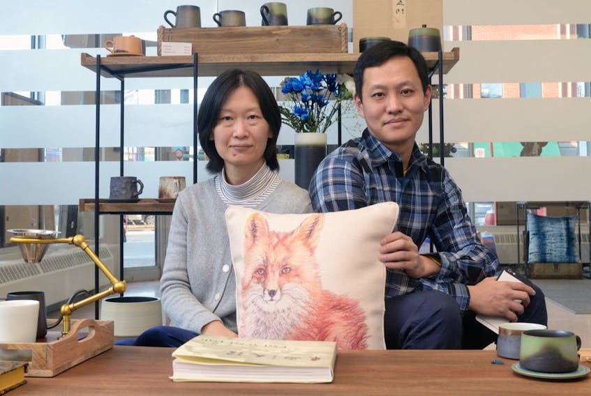 Xuhong Hu, left, and Yang Wang show some of the hand-crafted items including pillows with P.E.I. scenery and pottery at their Sealand Art Gallery and Gift Store, which is located at 150 Kent St. in Charlottetown. MITCH MACDONALD/THE GUARDIAN