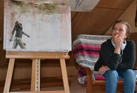 Artist Monica Lacey sits with a painting she’s working on at the new studio space she rents in downtown Charlottetown called The Vessel. KATIE SMITH/THE GUARDIAN