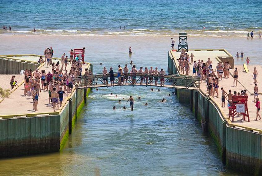 Beach-goers jump off Basin Head bridge in a Facebook post from July 11, 2014.
