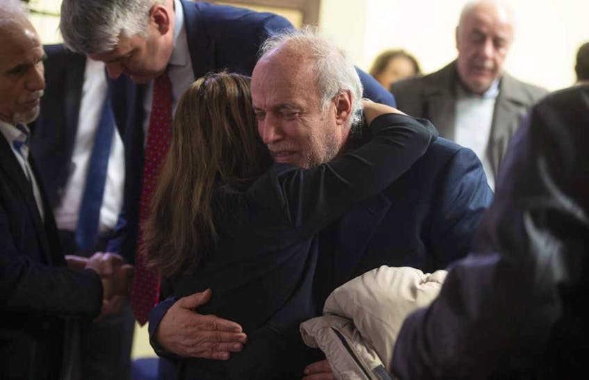Dr. Masoud Adibi is comforted following a memorial service on Thursday night at the Al Rasoul Islamic Society in Bedford for the victims of the Ukraine International Airlines plane crash in Iran. Adibi is the husband of Dr. Sharieh Faghihi, a Halifax dentist who was one of five Nova Scotians killed in the crash.