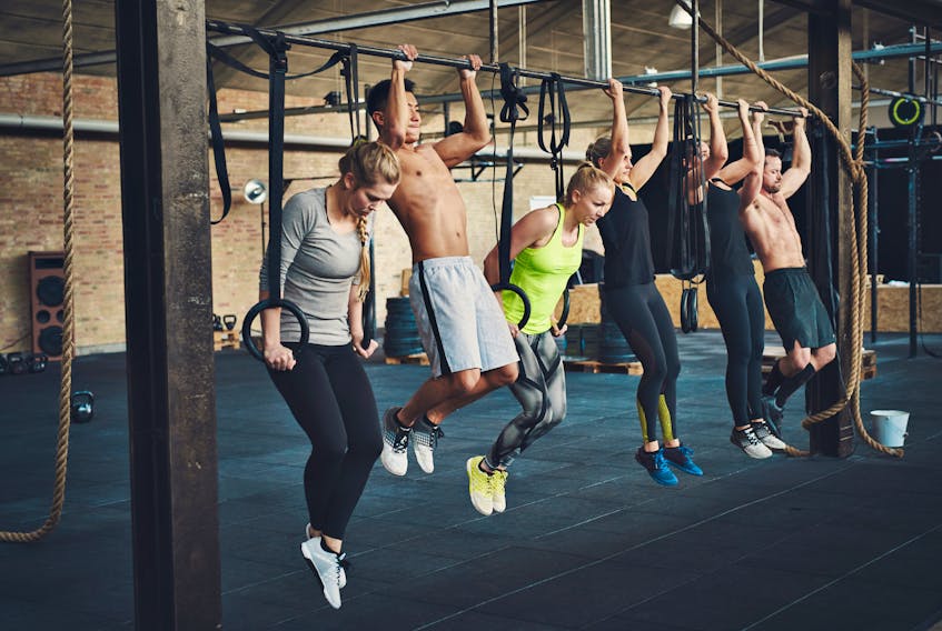 A group of people participate in crossfit training.