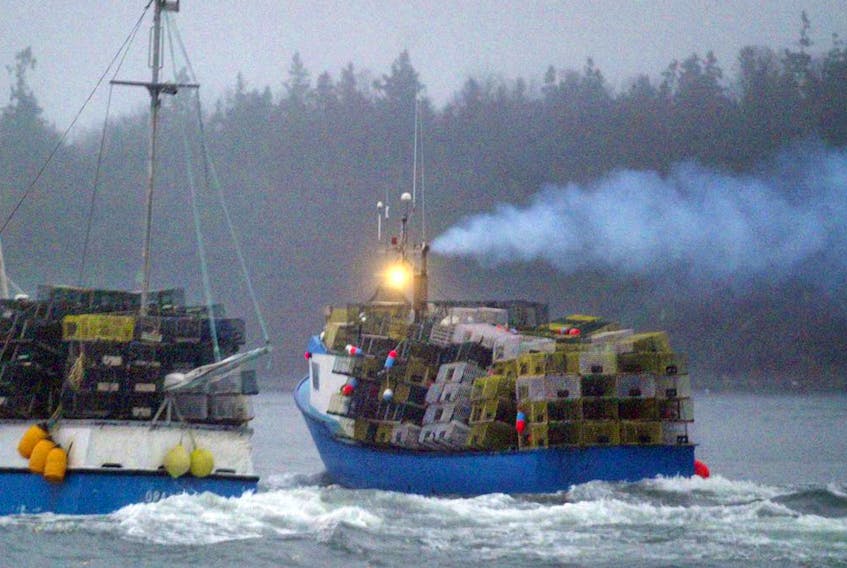 Two fishing vessels loaded down with lobster traps leave Eastern Passage in this file photo. this photo is being used for illustrative purposes only.