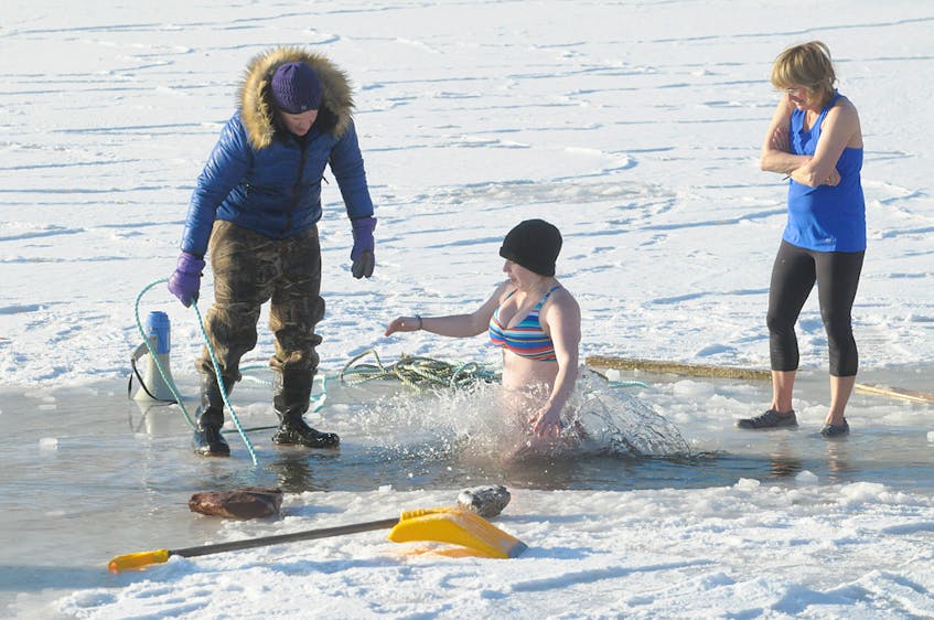 Walk out onto the ice, stand in the cold for your turn and then jump! That was the order of the day Monday during the annual polar bear dip. BRIAN MCINNIS/THE GUARDIAN