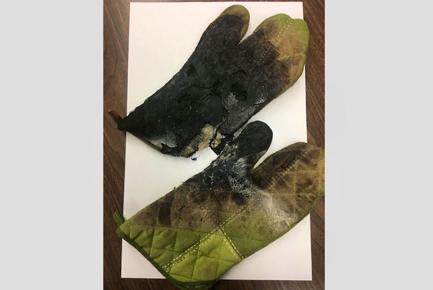 These ovens mitts, which were stored in the lower drawer of a stove, caught fire, causing significant smoke damage to a home in Burin. Burin Volunteer Fire Department's Facebook page