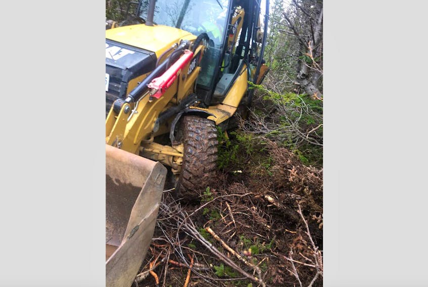 This backhoe, belonging to Mallays Industrial Services Ltd., was stolen in St. Lawrence and abandoned in a wooden area overnight on May 23-24. The bucket was removed and taken. - Michael Mallay (Facebook)