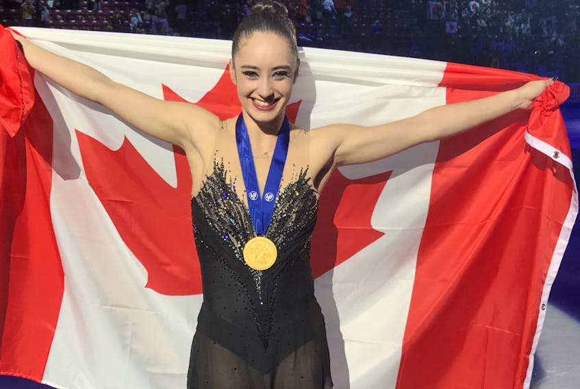 Kaetlyn Osmond celebrates her gold-winner performance at the world figure skating championships in Milan, Italy with the Canadian flag. - Skate Canada