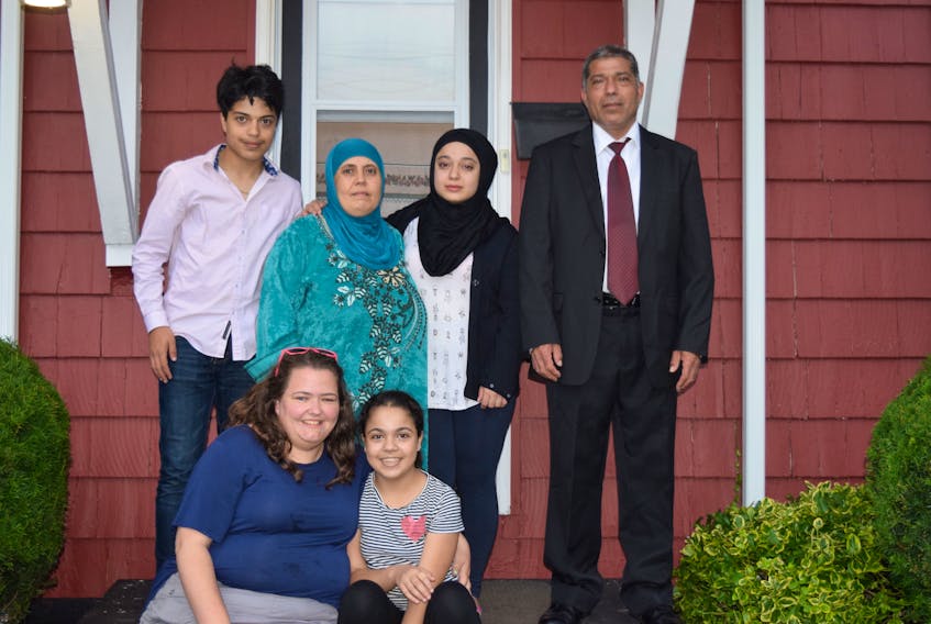 The Al-Hussein family fled Idlib in 2011, just as Syria’s civil war erupted and spent five years as refugees in Lebanon. They came to Nova Scotia two years ago, started working and bought their house in Truro last month. Back row, from left: Mohammed Al-Hussein, his mother Asayma Al-Mustafa, sister Ghufran and father Abdel. Front row, from left: family friend Hannah Gray and the Al-Husseins’ youngest daughter Alaa. Missing: eldest son Ahmad Al Hussein.