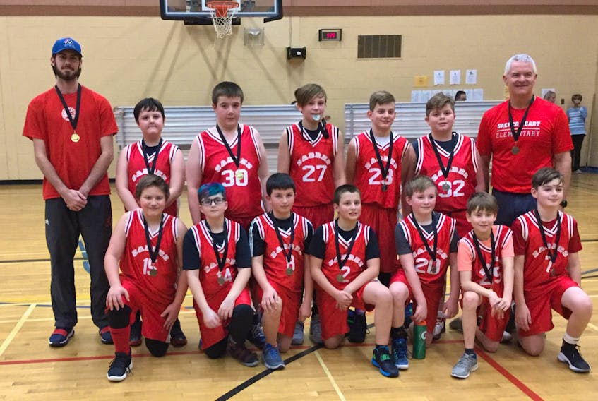 Members of the winning Sacred Heart Sabres team included, from left, (front) Jacob Eldridge (15), James Deluney (14), Lucas Murley (8), David Lushman (2), Noah Francis (20), Nathan Snooks (25), and Kevin Lambe (7); (back) coach Chris Dobbin, Landon Butt (26), Nathan Howell (30), Mason Pawley (27), Matthew Eddison (23), Gavin Doman (32), and coach Frank Humber.
