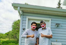 Samy and Ammar Hudhud pose for a photo at their home in Nova Scotia, where they moved in fall 2019. Leading up to Canada Day, the son and father duo crafted a couple hundred masks featuring Canada Day flags for people all over Canada to keep them safe and protected amid the COVID-19 pandemic.