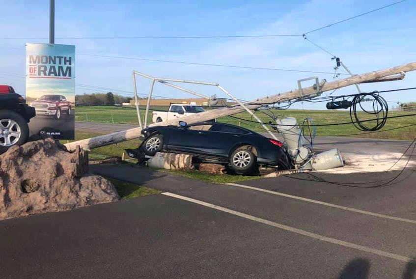 Amherst Police, the fire department and EHS responded to this single-vehicle crash in front of Amherst Chrysler on South Albion Street on Saturday afternoon. It was one of two crashes within several hours. - Facebook/Mike Allen photo