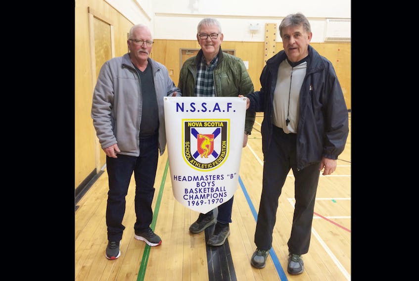 Wayne Smith, Alex Ryan and Doug Ryan played on the 1969-70 Inverness Rebels team that won a provincial high school basketball title.  The team’s original championship banner was lost when their school was torn down. A new banner was presented to the team during a recent ceremony.