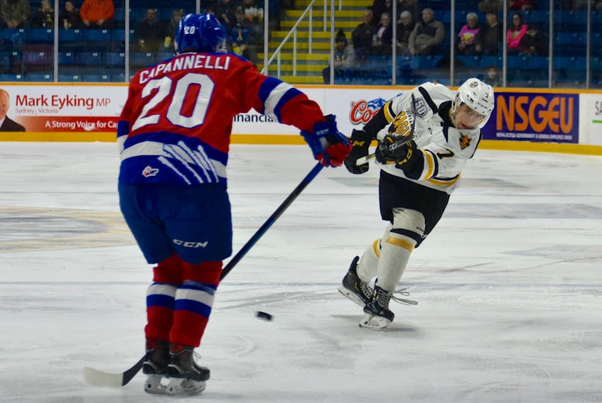 Adam McCormick of the Cape Breton Screaming Eagles, right, has his point shot blocked by Adam Capanneilli of the Moncton Wildcats during Quebec Major Junior Hockey League action at Centre 200 on Friday. Cape Breton won the game 3-2 in a shootout.