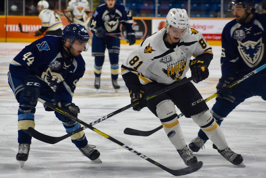 Mathias Laferrière of the Cape Breton Screaming Eagles, middle, breaks through Sherbrooke Phoenix defencemen Olivier Crête-Belzile, left, and Ryan DaSilva, right, during Quebec Major Junior Hockey League action at Centre 200 on Wednesday. Cape Breton won the game 5-1.