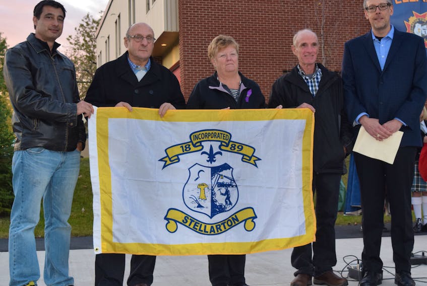 The Town of Stellarton marked its 128th birthday on Oct. 20 by raising the new official town flag. From left are town councillors Simon Lawand, Bryan Knight, Susan Campbell and Garry Pentz; and Mayor Danny MacGillivray.