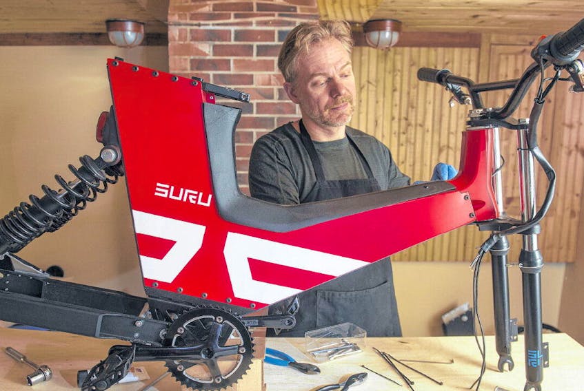 Michael Uhlarik works on one of his SURU e-bicycles at his home in Hubbards on Tuesday morning. SURU recently received $50,000 in funding and business guidance through Innovacorp's Spark Innovation Challenge. 
RYAN TAPLIN •THE CHRONICLE HERALD