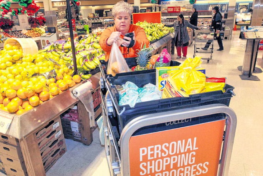 Carmel Pendergast, personal shopper at the Joseph Howe Superstore in Halifax, fills a couple of orders from online Monday. The grocery giant now offers personal online shopping. 
ERIC WYNNE • THE CHRONICLE HERALD