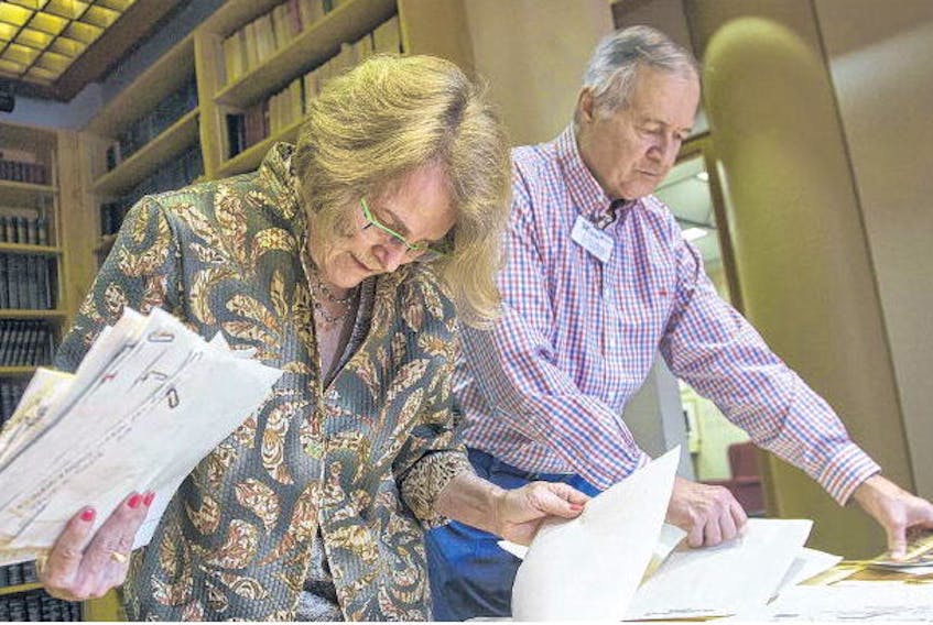 Mary Balkam and her husband Eric sift through letters from Halifax Explosion survivors and their families that had been collected by Balkam’s aunt, Jean Davis, at the Nova Scotia Archives in Halifax on Tuesday. (TIM KROCHAK • THE CHRONICLE HERALD)