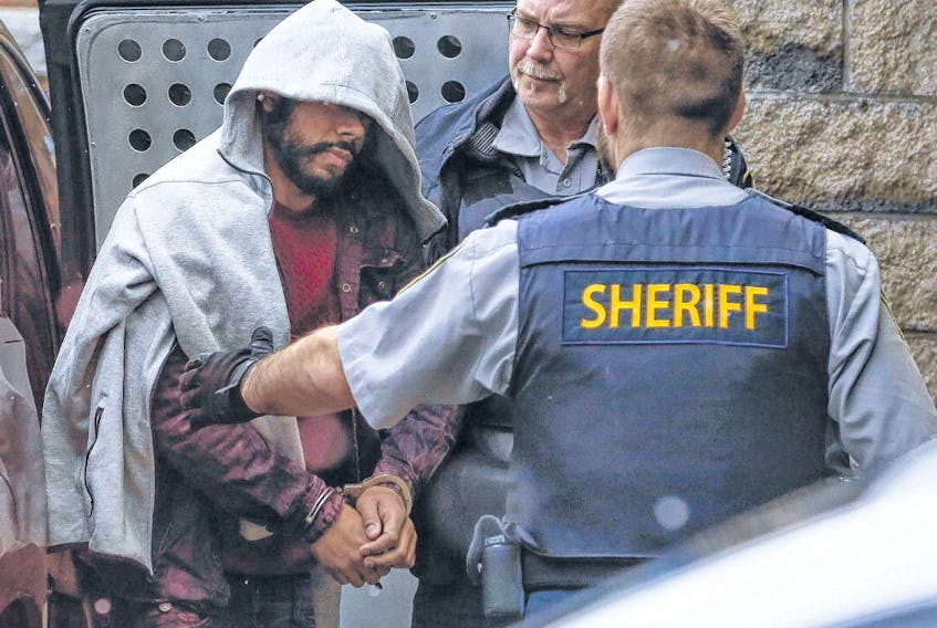 Tyrell Peter Dechamp, 27, is led from a vehicle by provincial sheriffs upon arrival at Halifax provincial court in Halifax on Monday. Dechamp is charged with two counts of first-degree murder in the 2016 shooting deaths of Tyler Richards and Naricho Clayton in Halifax as well as one count of attempted murder. 
TIM KROCHAK • THE CHRONICLE HERALD