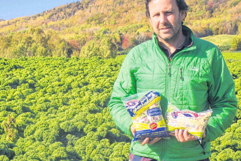 Andrew Rand of Randsland Farms holds some of the products grown in his fields. 
CONTRIBUTED