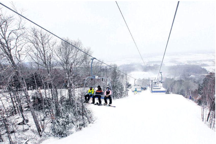 Snowboarders head up the chairlift at Ski Martock on Thursday. With colder temperatures across the province making ideal snow-making conditions, Nova Scotia ski hills are anticipating opening more runs soon. 
ERIC WYNNE • THE CHRONICLE HERALD