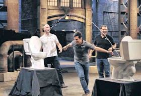 Goulds native Ed Barrett (left) looks on as his stepbrother Carlos Barrozzi (centre) dashes under a stream of water shooting from a Superior Bidet while filming a segment for the CBC-TV reality show “Dragons’ Den.” Their brother, Mark Barrozzi, who founded the company in 2015, is at right. The stepbrothers filmed the segment in 2017. File