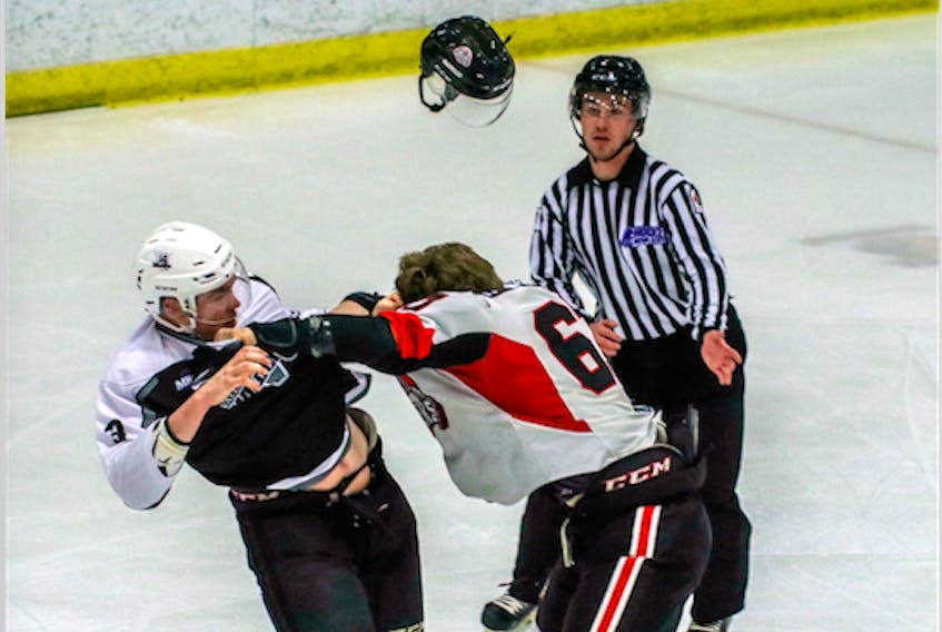 A difference of opinion? Mark Kennedy with the Wildcats, left, and Tyler Hutchinson with the Crushers tangle midway through the first period. Both players received game misconducts for fighting.
