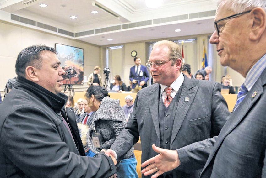 Morley Googoo, a regional chief of the Assembly of First Nations, shakes hands with councillors Steve Streatch and Bill Karsten after Halifax regional council voted to remove the Cornwallis statue on Tuesday. TIM KROCHAK • THE CHRONICLE HERALD