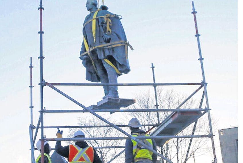 The statue of Edward Cornwallis is lifted from its base in the park that still bears his name in Halifax on Wednesday. TIM KROCHAK • THE CHRONICLE HERALD