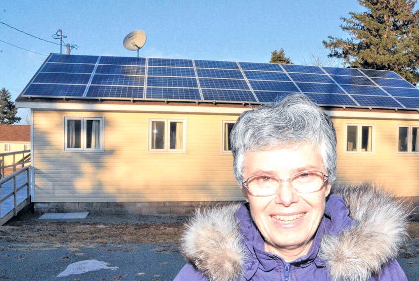 Sister Donna Brady with an array of solar panels the Sisters of St. Martha had installed to reduce their carbon footprint and their energy costs.
AARON BESWICK • THE CHRONICLE HERALD