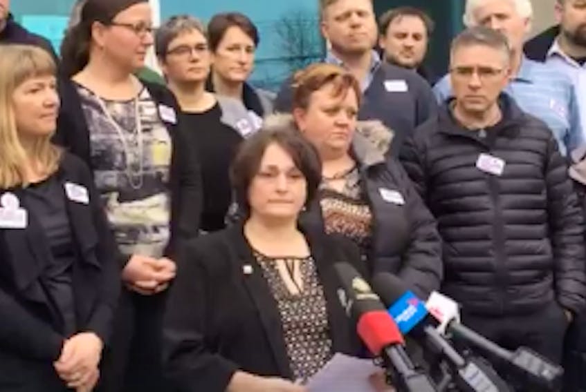Nova Scotia Teachers Union president Liette Douce, surrounded by members of the union's executive, speaks at a press conference in Halifax Feb. 21.