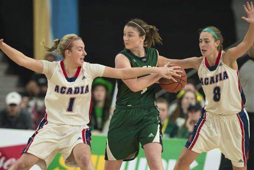 Acadia’s Ellen Hatt (1) and Katie Ross (8) defend against UPEI’s Jenna Mae Ellsworth during the AUS women’s basketball championship final at the Scotiabank Centre on Sunday afternoon. (RYAN TAPLIN / The Chronicle Herald)