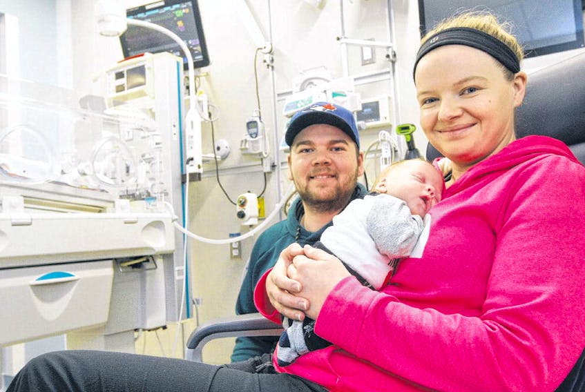 With dad Thomas White at her side, Lori Robinson holds her son Duncan, who was born at 28 weeks, in one of the new NICU rooms at the IWK hospital Thursday. Twin brother Sullivan is still in the NICU for some breathing issues. Duncan and Sullivan are now 75 days old. ERIC WYNNE • THE CHRONICLE HERALD