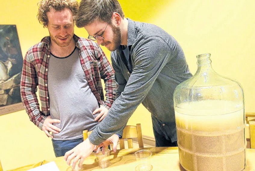 Adam Maclaren chats with Nathaniel Geoffrion before pouring out a sample of their of South African Xhosa beer, Umqombothi, which was one of the 16 different heritage brews, some recipes dating back to the 18th and 19th centuries, that were being presented at their class at the University of King’s College in Halifax on Wednesday.
TIM KROCHAK - THE CHRONICLE HERALD