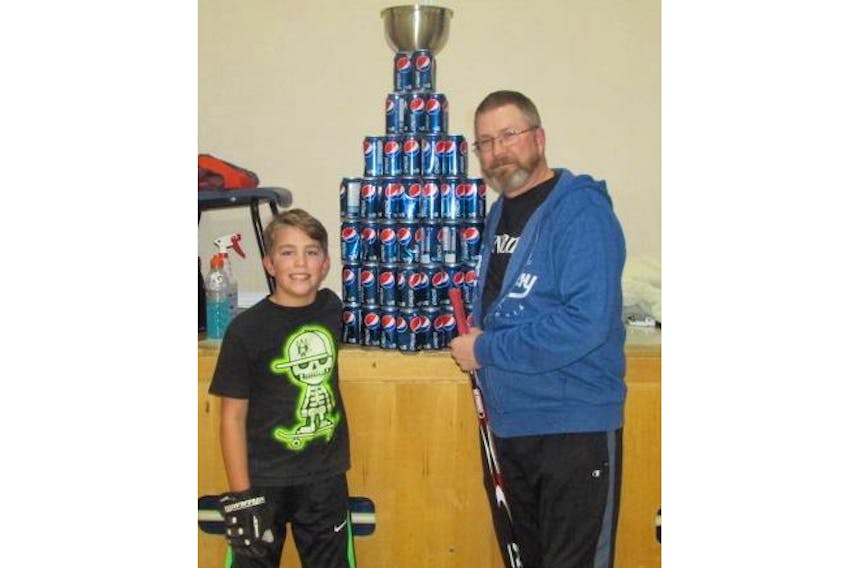 Greg and Quinn Pemberton with the Pepsi can cup. The winning team of Hockey Nights in Weymouth gets the Pepsi can cup title.