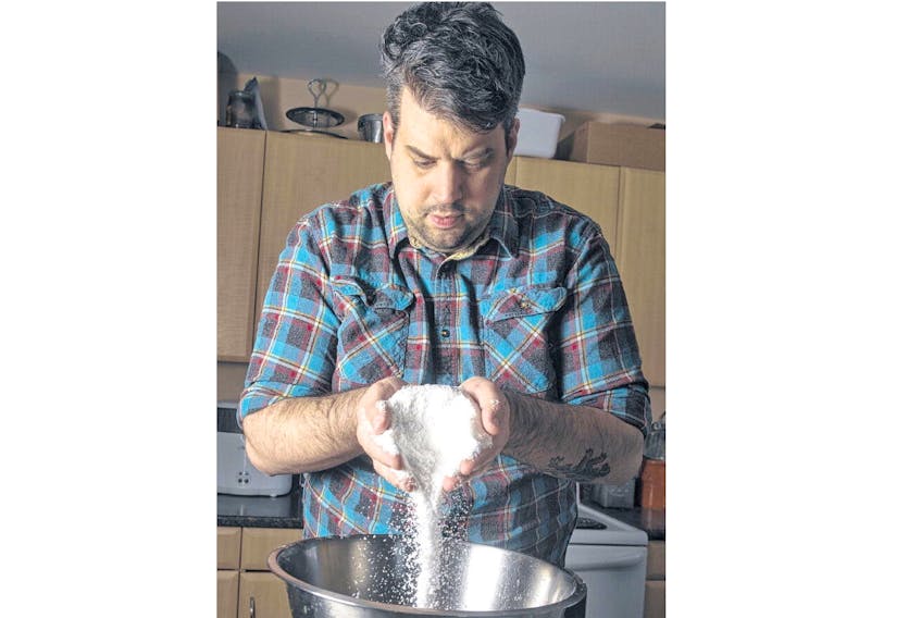 Colin Duggan pours salt into a bowl in his Dartmouth kitchen on Tuesday evening. Duggan and his wife Audrey make sea salt from Nova Scotia’s ocean waters and sellboxes of Tidal Salt online to customers across North America and the U.K. RYAN TAPLIN • THE CHRONICLE HERALD