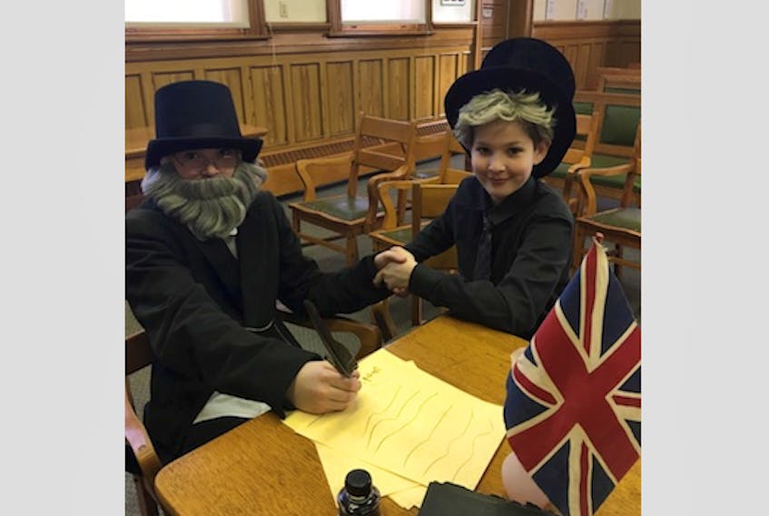 Sam Churchill, left, and David McCulley show off the costumes they wore while filming a French Heritage Minute for a recent school assignment at the Kings County Museum.