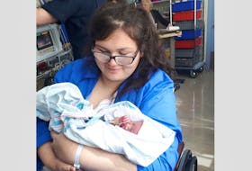 New mom Ocean Johnstone holds her daughter, Rain. Johnstone gave birth in the car while travelling between the exits for Berwick and Coldbrook on Highway 101 en route to Valley Regional Hospital in Kentville May 15.