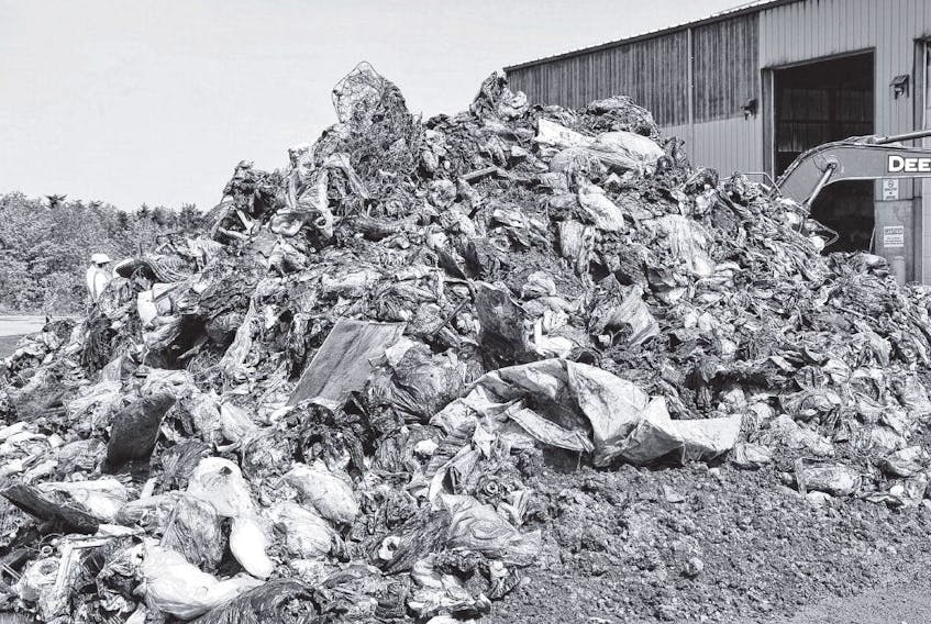 A pile of burnt rubble was removed from the waste and recycling transfer station that was damaged in a Sunday fire at the East Hants Waste Management Centre in Georgefield. FRANCIS CAMPBELL • THE CHRONICLE HERALD