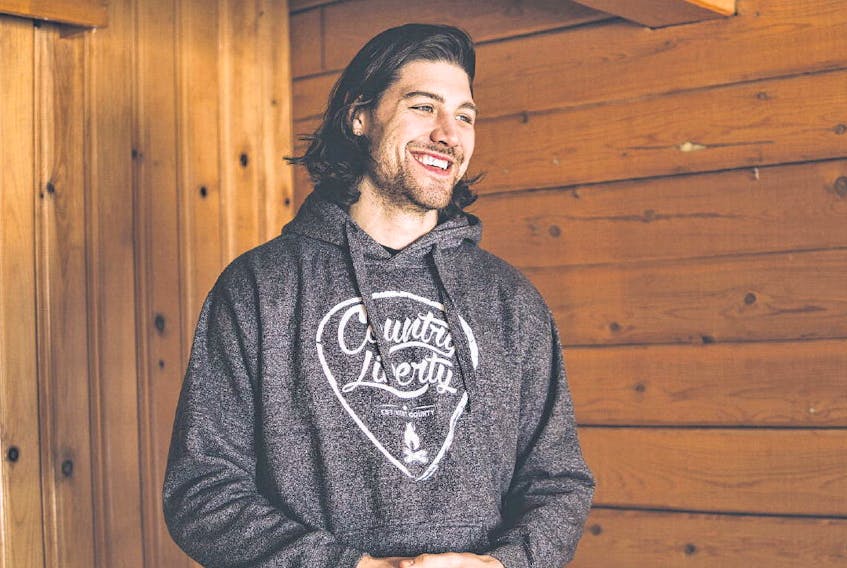 Sawyer Hannay wears one of the items from his clothing brand, a Country Liberty sweatshirt. COUNTRY LIBERTY