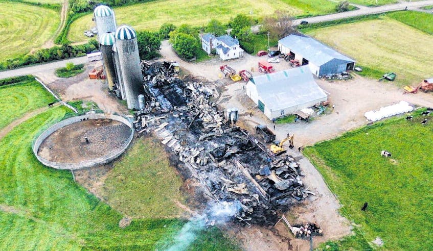 A fire overnight destroyed the barn at the Aaron Rovers farm near Afton. CHARLES RILEY