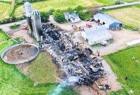 A fire overnight destroyed the barn at the Aaron Rovers farm near Afton. CHARLES RILEY