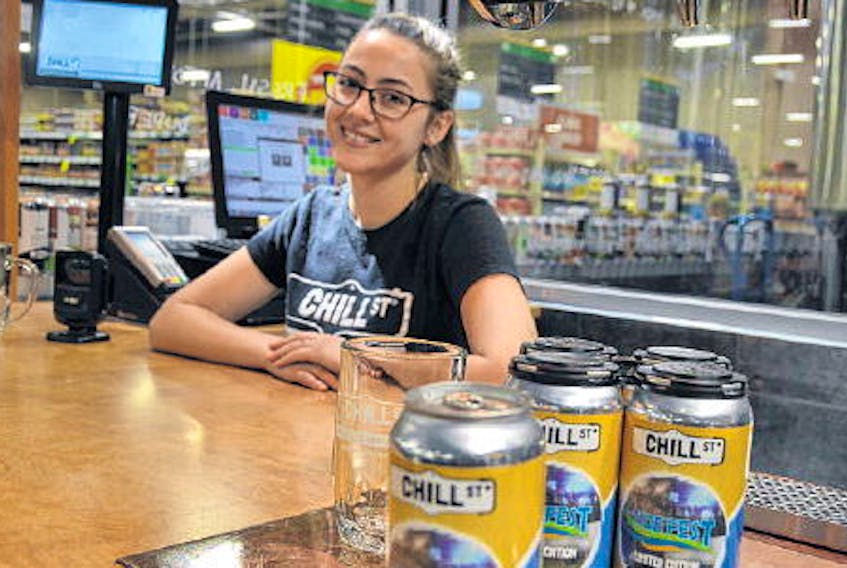 Emily Solway-Ferguson offers customers a taste of the Chill Street Fresh Beer and Cider Market products before they decide to purchase. FRANCIS CAMPBELL • THE CHRONICLE HERALD