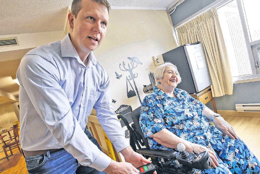 Paraglide developer Matt MacKenzie is seen with Northwood resident Anne Hicks as he prepares to demonstrate his invention at the care facility in Halifax on July 12. The remote control allows residents to reposition themselves in their wheelchairs via an attachment known as the Paraglide. TIM KROCHAK
