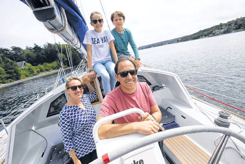 Rhiannon Davies and her family, Emma,12, Macsen, 10, and husband, Sebastiaan Ambtman, are seen on their sailboat, Dutch, in Halifax on Wednesday. The family spent the last year sailing 15,000 nautical miles and visiting 17 countries in Europe, West Africa, South and North America before settling in Halifax for the school year. TIM KROCHAK