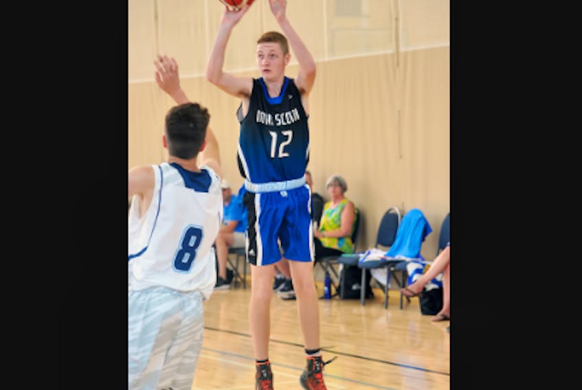 Kaj MacVicar, right, takes a jump shot from just inside the three-point arc during the bronze-medal game at the 2018 U-15 boys’ national basketball championships.