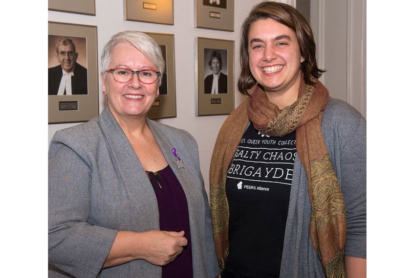 Transportation Minister Paula Biggar speaks with Hannah Gehrels, representing the PEERS Alliance, after an announcement Friday of new gender choice options on driver's licences.