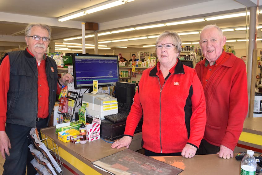 Brian Ellis, left, store manager at the Home Hardware store on Willow Street has been working at the site for more than 50 years, including when it was initially a Canadian Tire store. He is seen with cashier Paulette Mattinson, who has worked there for about 35 years and owner Les Mosher, who began working part time at the store at age 12 when it was owned by his father Walter.