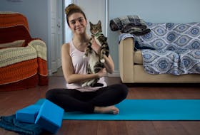 Journalist Millee McKay - pictured with her feline companion Jinx -  shares some of her favourite yoga poses.